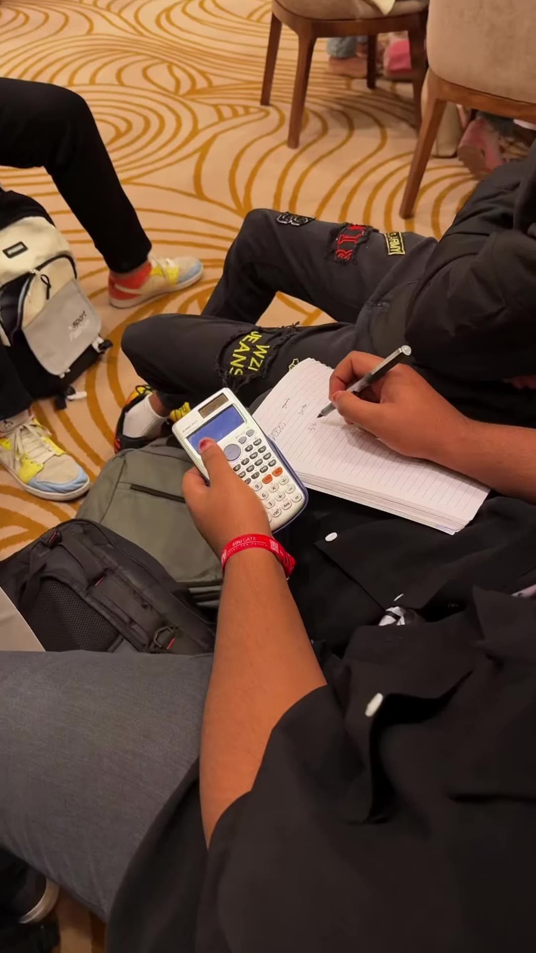 A student working through a problem with a calculator