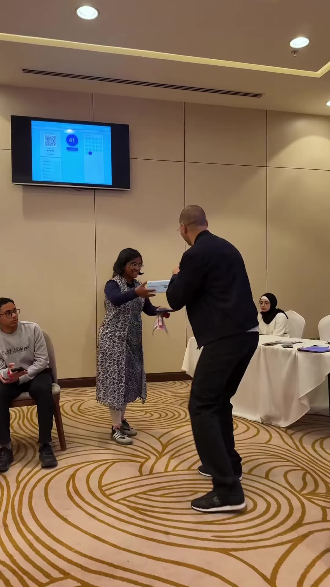 A prize handed to a student in the audience