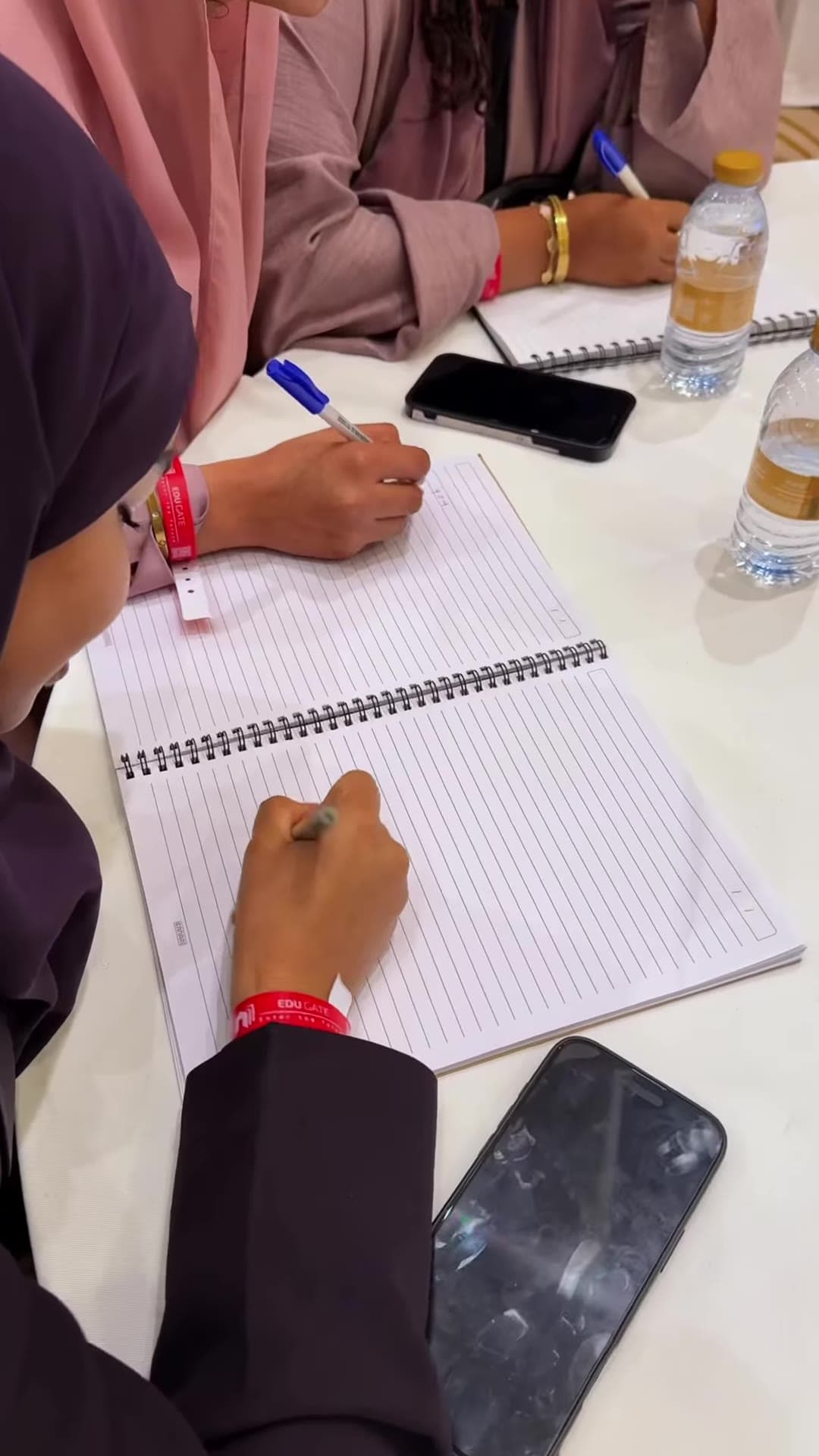Students taking notes during an educational session